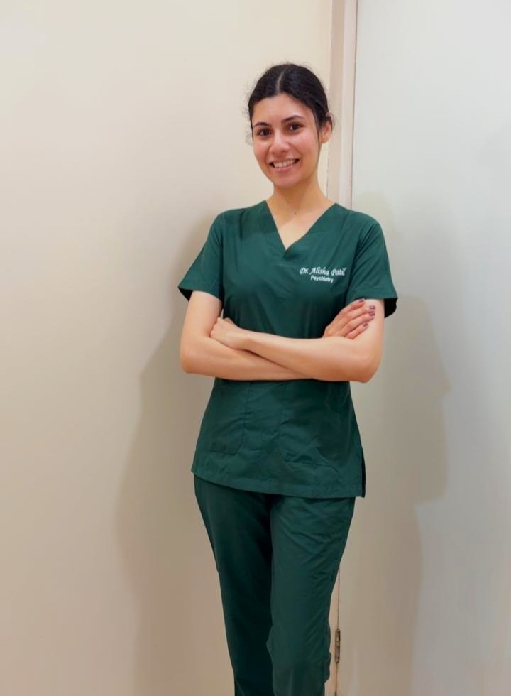 Dr. Alisha Patil in clinical scrubs